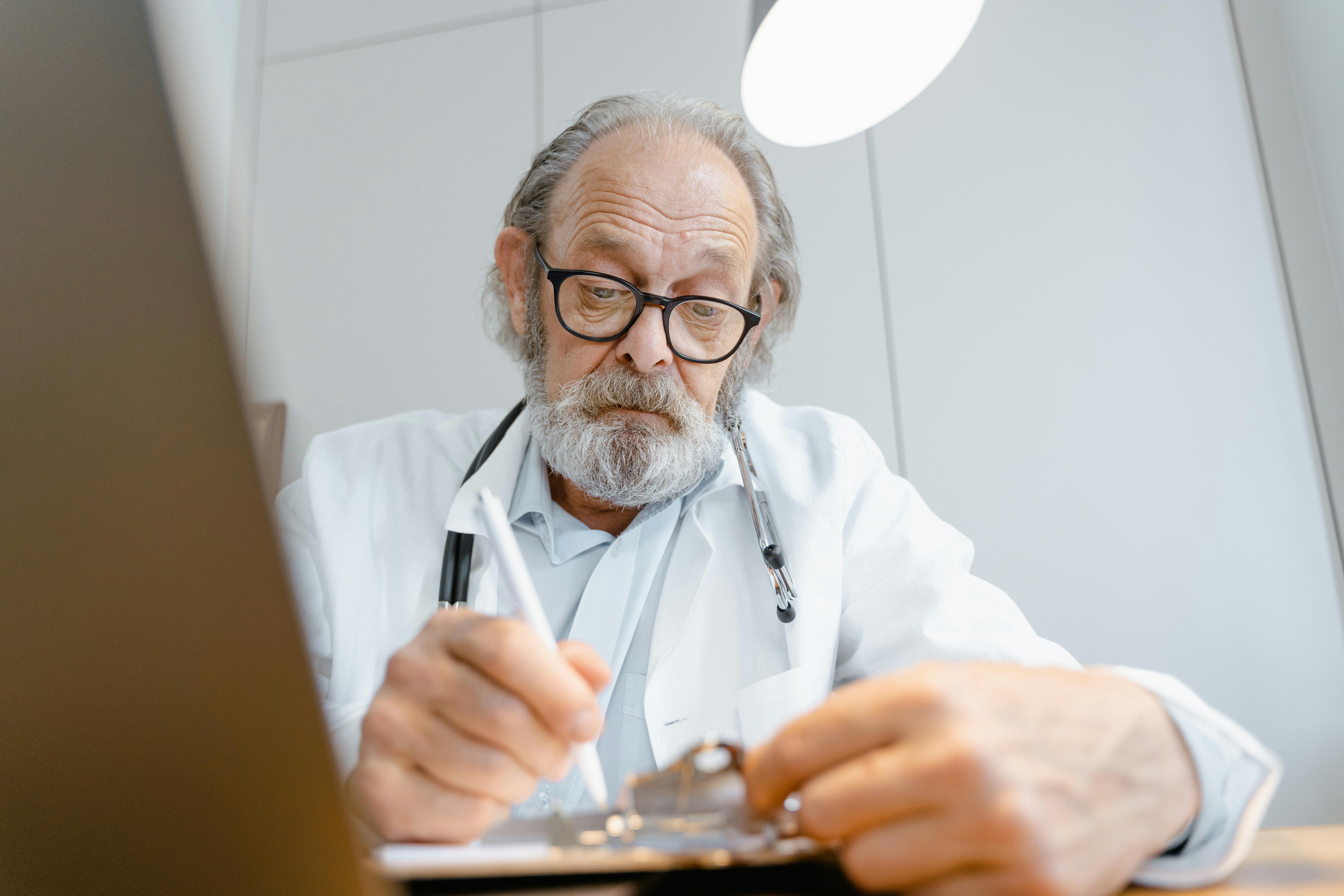 Doctor using pen and paper before transitioning to HIPAA compliant file sharing software